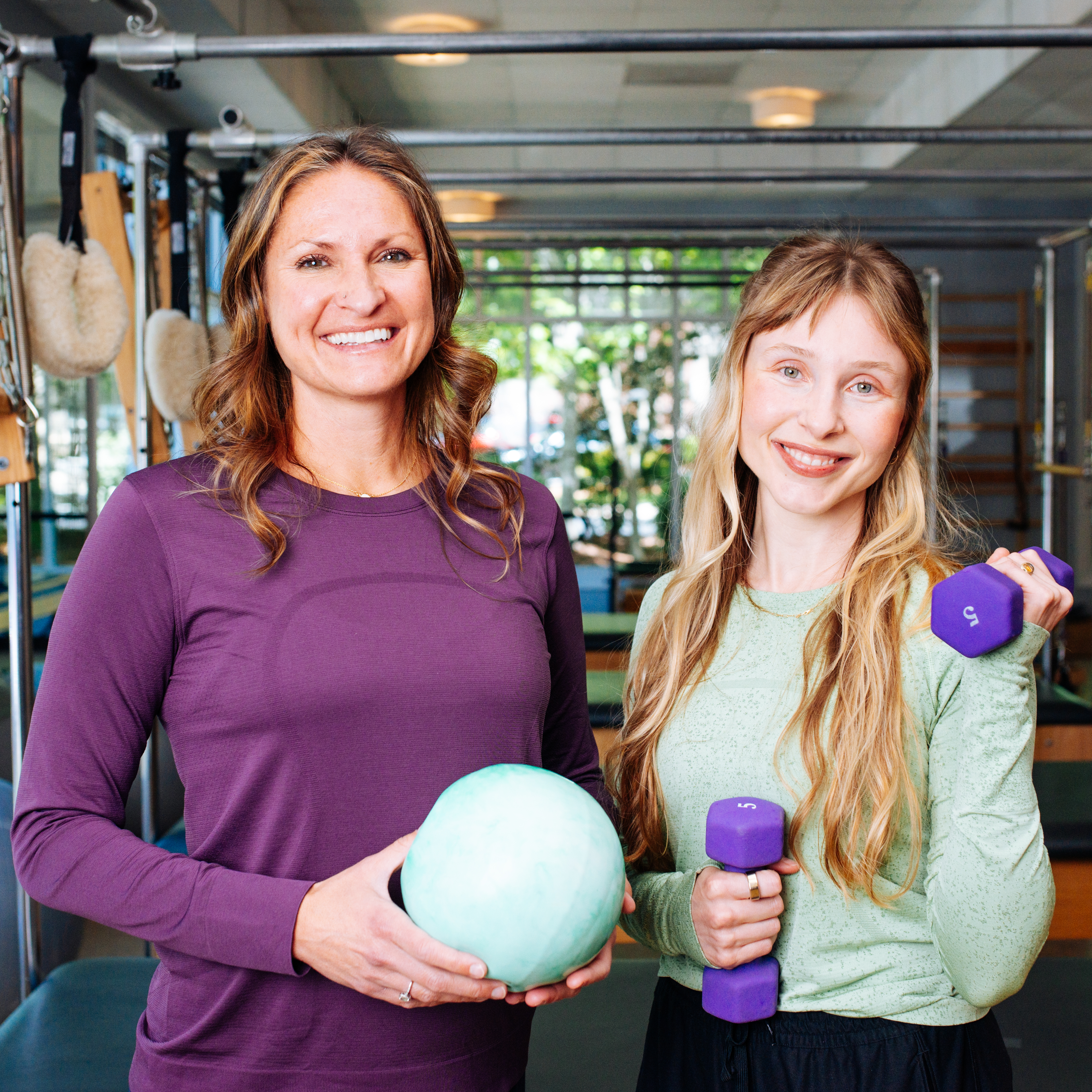 Mischa and Meredith pose with pilates PT props.