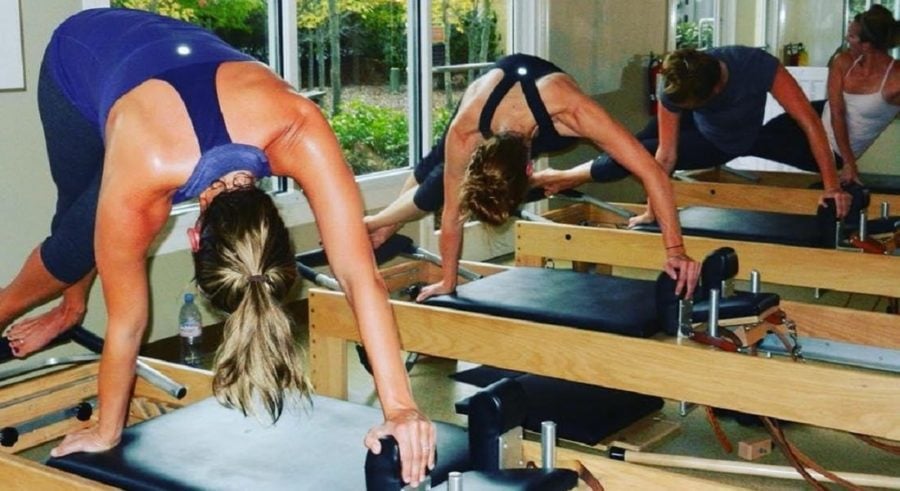 A woman is doing some kind of exercise on the gym equipment.