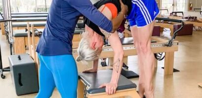 A woman helping another person with her balance