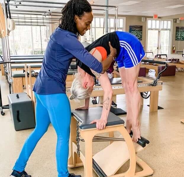 A woman helping another person with her balance