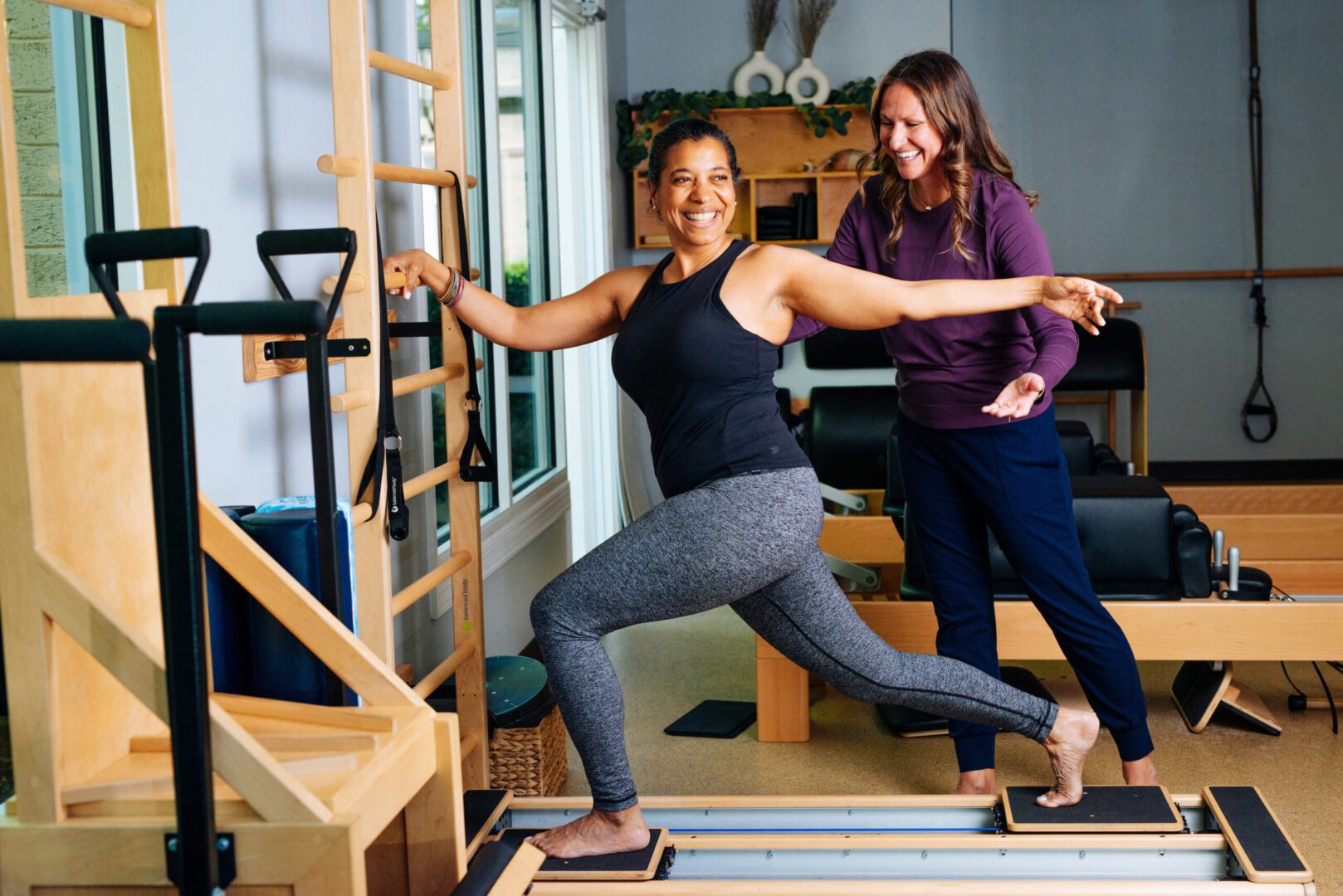 Mischa works with a Pilates client.